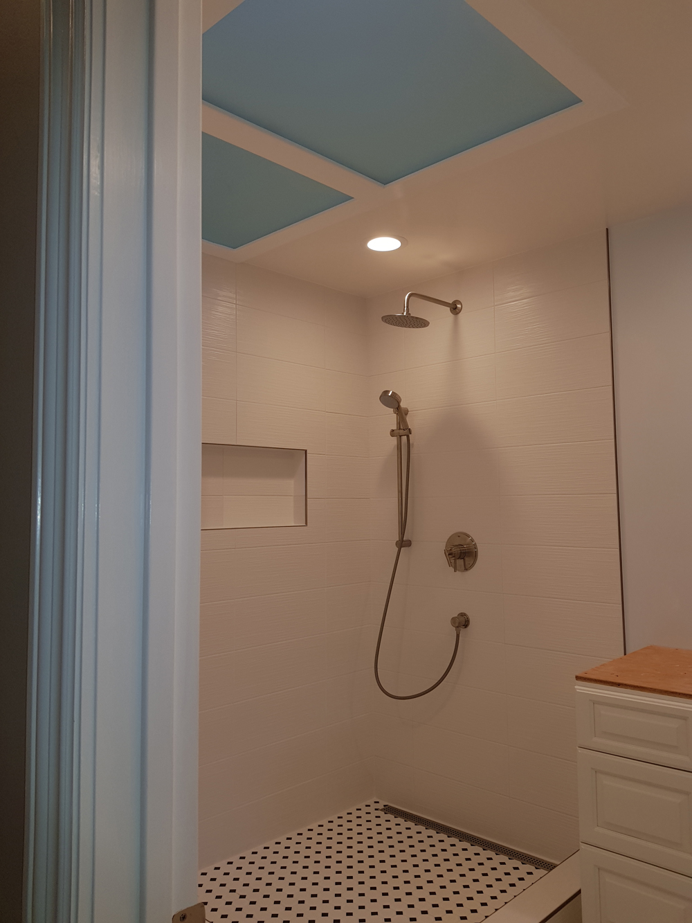 Bathroom with pale pink walls and ceiling and a high shower area