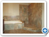 Screenshot of a bathtub and shower space with marble tiles