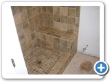 Screenshot of a shower space with brown marble tiles on the walls and ceiling