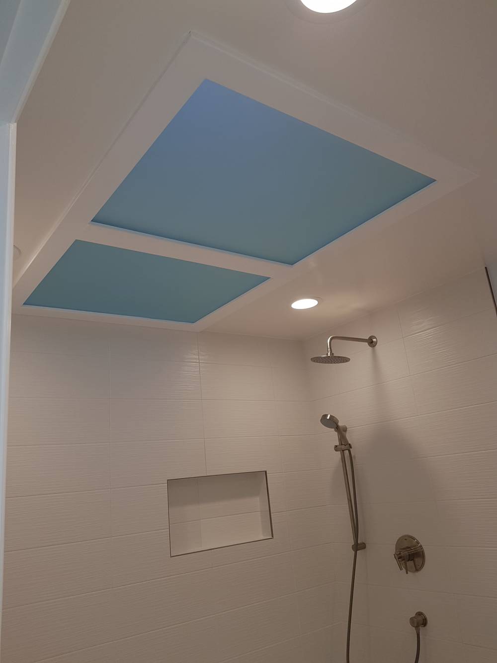 Light blue sun roof of a pale pink shower room